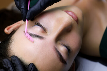 long-term eyebrow styling procedure the master combs the eyebrow hairs with a brush lamination...