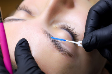 close up of the master's hands holding the brush the master directs the growth of hairs after...