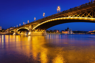 View of bridges in Budapest, Hungary. Parliament building, bridges and the Danube River.  Classic blue hour photo.