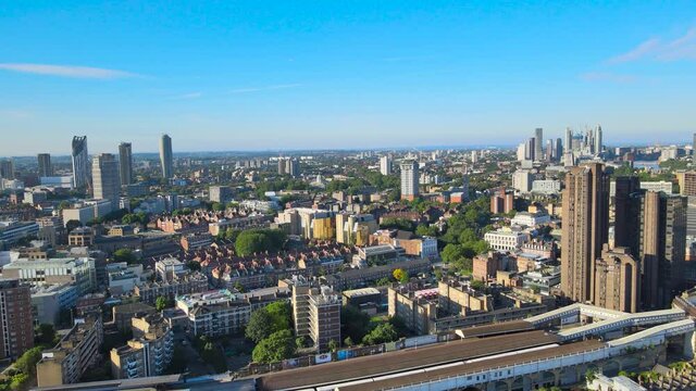 fly above Waterloo neighbourhood. Aerial view of mixture of various buildings. Clear blue sky. London, UK