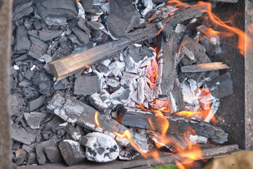 Close-Up Of Burning Coal On Metal Grill