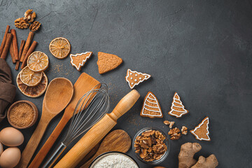 Festive culinary background. Ingredients, ginger cookies and cooking utensils on a brown background. Copy space