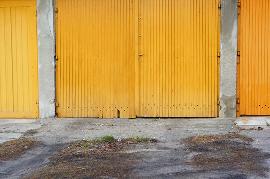 Closed Yellow Front Door Of A Garage