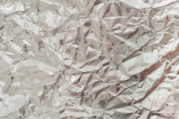 Crumpled silver aluminum foil as background 