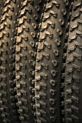 Group of new bicycle tires. Rubber tires close up. Bicycle tires with the same tread pattern.