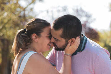 
a fat couple about to kiss in a park