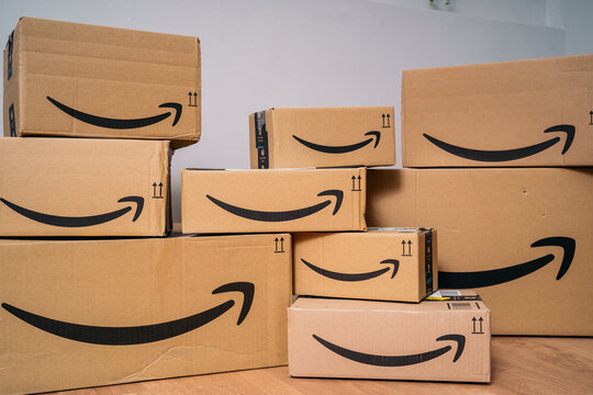 MADRID, SPAIN - AUGUST 31, 2021: Set of a lot of amazon packages of different sizes, showing their arrow in the shape of a smile as a brand of the company