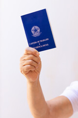 Holding a brazil work permit card, isolated on white background. Concept image.