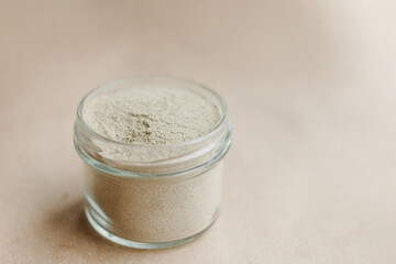 Ayurvedic cosmetic ubtan for face and hair care in glass jars. Vegetable ingredients ground into a powder