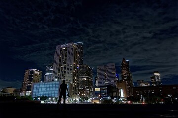Silhouette of man staring at Houston skyline