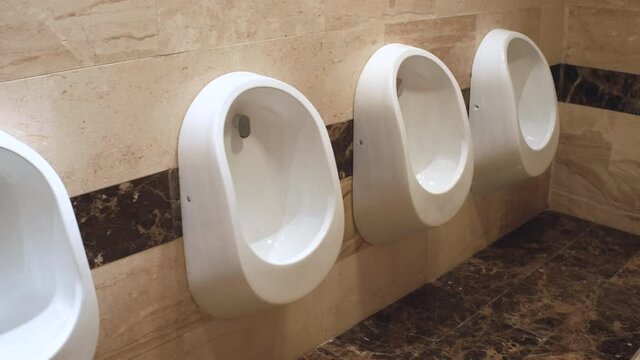 Restroom Interior. A row of urinals in the toilet for man