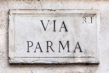 marble plate with street name via Parma - engl: Parma street - pat the wall in Rome