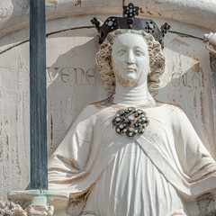 Ancient aged sculpture of beautiful Noble woman with sword and papyrus at Doge Palace in Venice,...