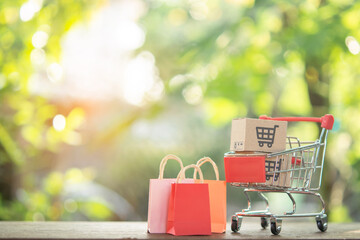 Shopping concept - Shopping cart or trolley, Shopping bags and Paper cartons or parcel with a...