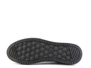 Black leather sneakers. Casual men's style. black rubber soles. Isolated close-up on white background. Shoe sole view. Fashion shoes.