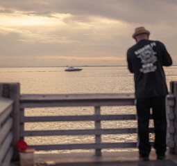 Fototapeta premium person on the pier horizon boat sea sky florida Key Biscayne man fishing hat 