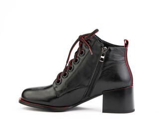 Women's autumn black leather jodhpur boots with red laces and average heels, isolated white background. Left side view. Fashion shoes. Photoshoot for shoe shop concept.