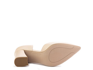 Classic and elegant suede high-heeled women shoes. Stylish beige shoes on high block heels and with a pointed toe. Isolated object close up on white background. Shoe sole view. Fashion shoes.