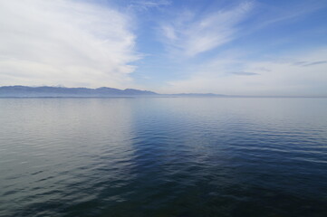 a sunny winter day on lake Ammersee in Germany with the Alps in the background
