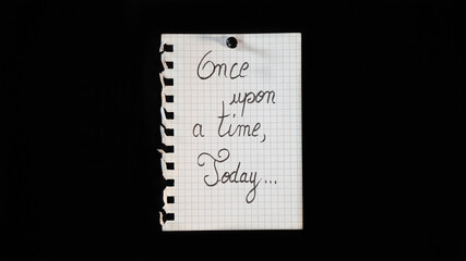 Hand written message on a ripped notebook sheet, "Once upon a time"	