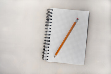 A PENCIL ON A NOTEBOOK