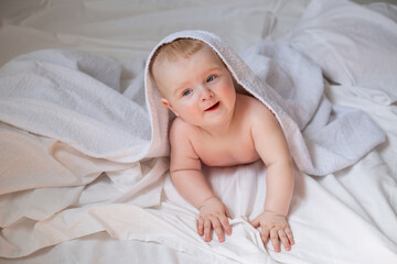 Fototapeta na wymiar a cute baby is lying in diapers in a bed with white cotton bed linen. High quality photo