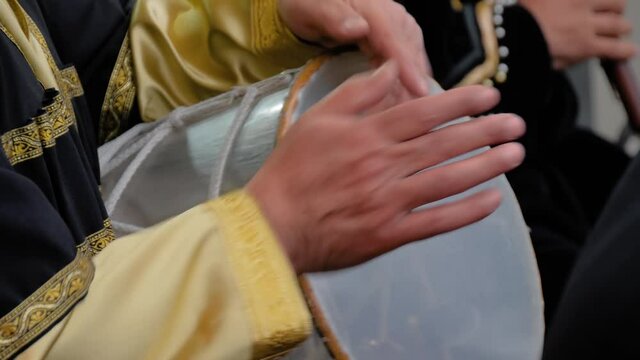 Slow motion: man hands playing ethnic azerbaijani percussion drum nagara on stage of summer open air concert - close up view. Entertainment, music, culture, leisure time and art concept