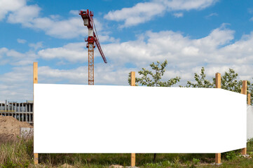 Blank white advertising banner on the construction cite fence