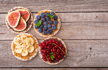 Rice cake with banana  blueberry redcurrant and figs