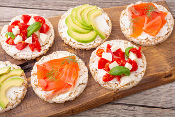 Rice cake with  salmon avocado mozzarella  and tomatoes