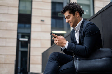 The financier checks the rates on the stock exchange in the phone in the application. The...