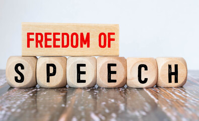 FREEDOM OF SPEECH, text on white paper on yellow background