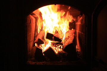 Fireplace photo. Cozy place in
opposite of the fire in country house.