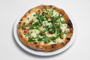 closeup of seafood pizza with shrimp, mussels and arugula on white background