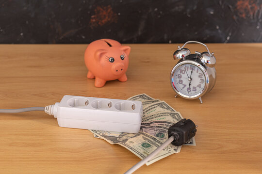 plug ruler with dollar money and a piggy and a clock with selective light bulb