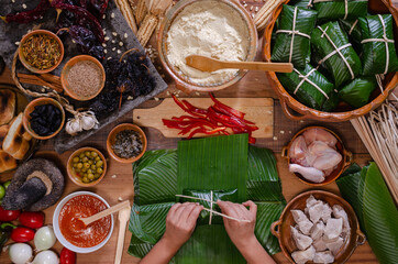 Hands making Guatemalan tamales.