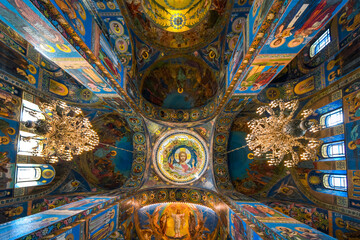 Fototapeta na wymiar The ceiling, columns and walls covered in mosaics depicting religious scenes inside the Church of Our Savior on Spilled Blood, Saint Petersburg Russia