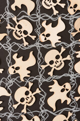 halloween themed wooden shapes arranged on a black and white grid background