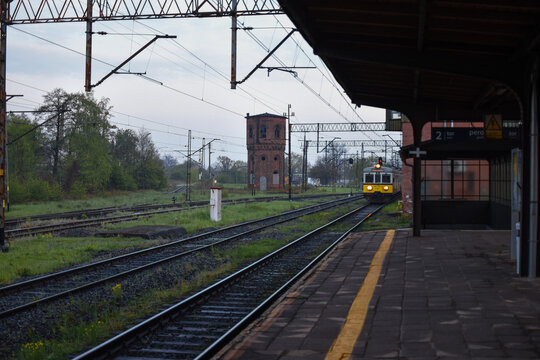 An old train arriving at a Ścinawa station in Poland in the morning.