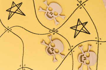 halloween themed wooden shapes (scary monsters and skull and crossbones) on a yellow background