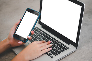 hand holding phone mockup image blank screen computer laptop for advertising text in workplace desk at office.