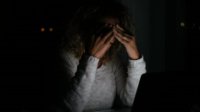 Tired and frustration woman working and using laptop at late night. Businesswoman upset to have work too much 
