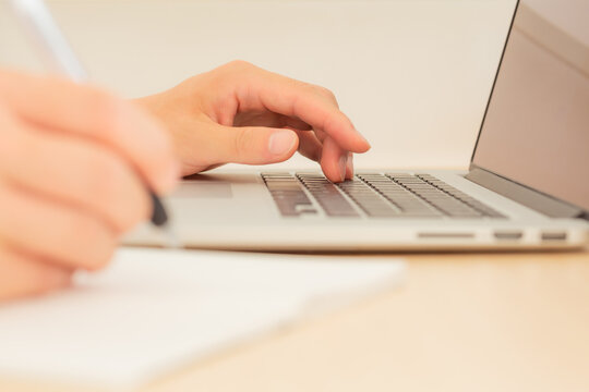 hand of freelancer working remotely on a laptop computer in tokyo, japan