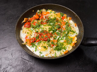 Fried eggs in a skillet on a black background. Studio photography