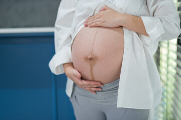 beautiful pregnant women, mother holding baby in pregnant belly
