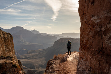 Female Backpacker Stands on the Edge of the South Kaibab Trail