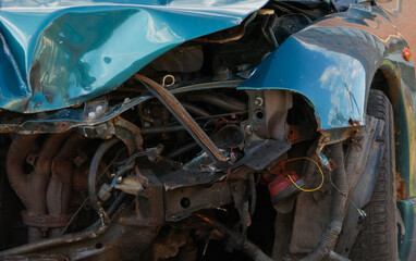 Fototapeta premium An image of a badly dented bumper and fender of a car. Unsuitable car.