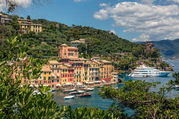 Fototapeta na wymiar Panorama of Portofino seaside area with traditional colourful houses, harbour with numerous of yachts and ships, view from Castello Brown, Liguria, Italy