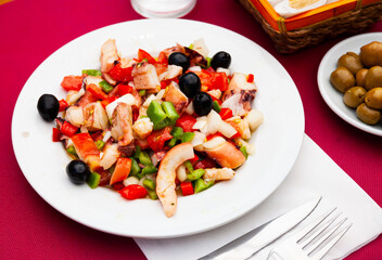 Traditional Spanish Salpicon de Marisco, cold salad from various seafood with vegetables and olives