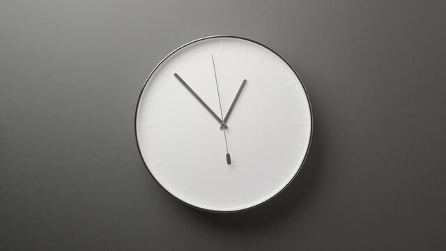 Clock Face on Dark Grey Office Wall in Timelapse